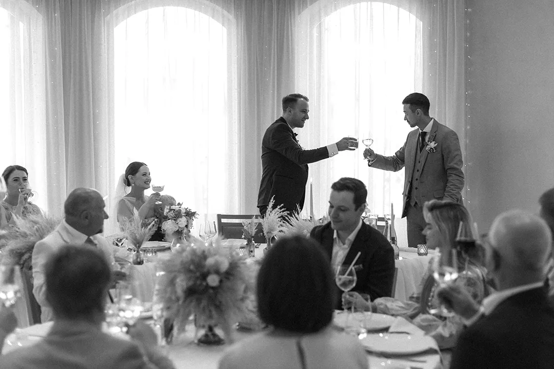 Axel raising a toast with the groom